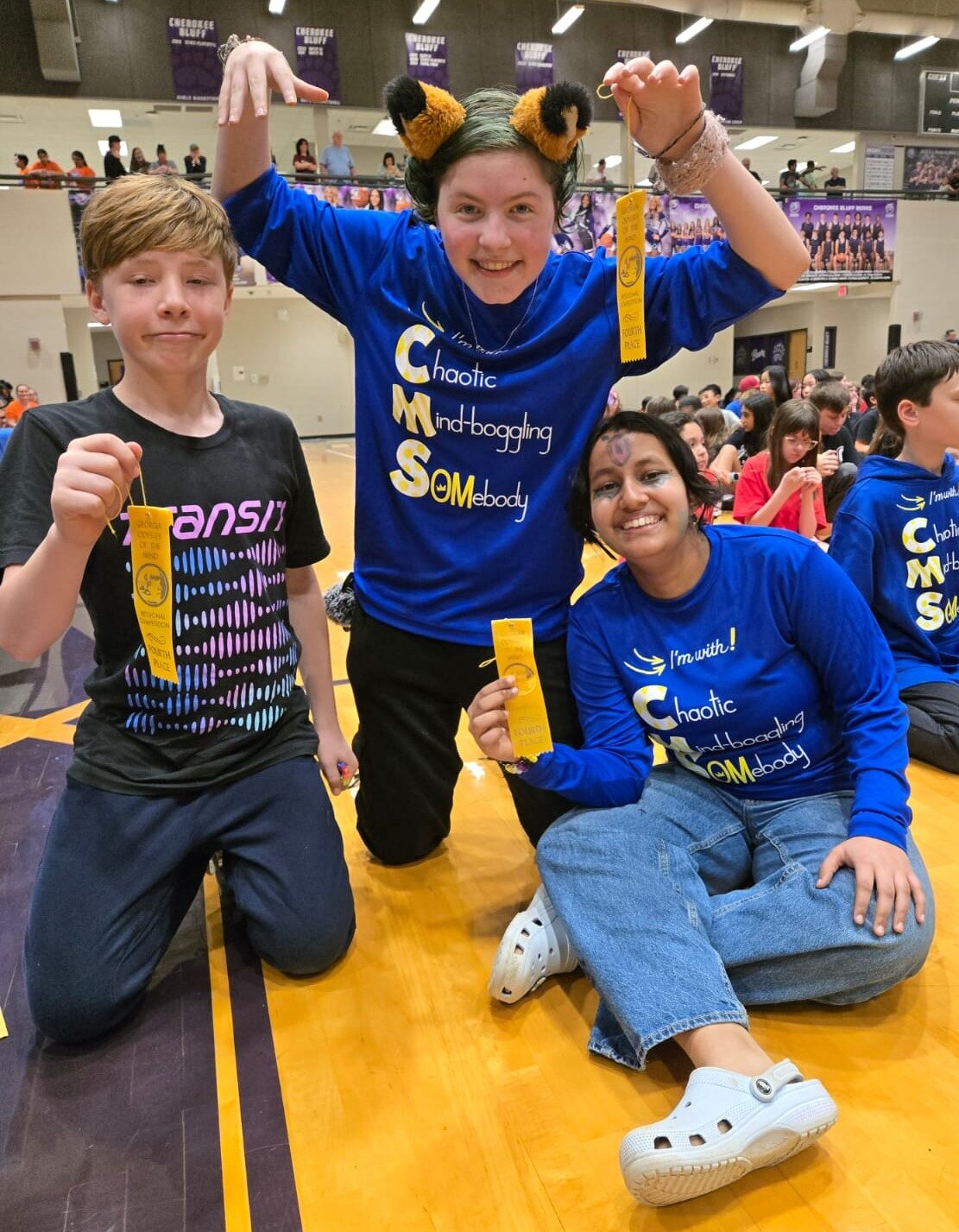 Chamblee Middle Odyssey of the Mind students celebrating with regional competition ribbons