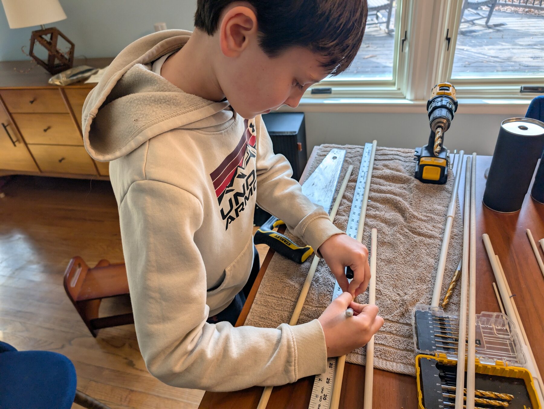 A student measuring materials while engineering an Odyssey of the Mind solution